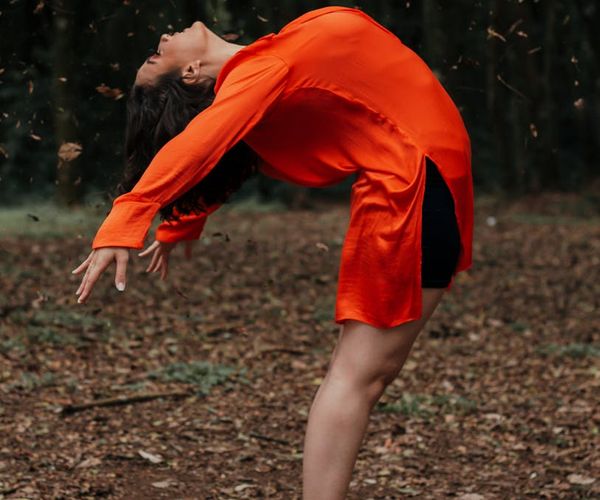 Person stretching outdoors, feeling flexible and full of life.